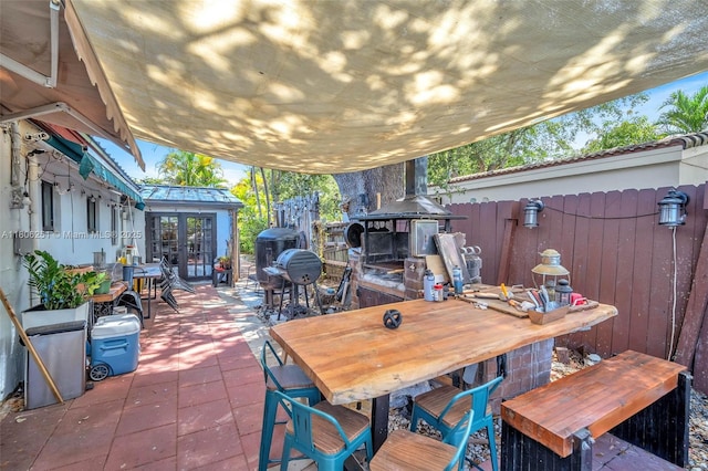 1635 NE 174th St, North Miami Beach, FL 33162 - view of patio / terrace featuring french doors and outdoor dining space