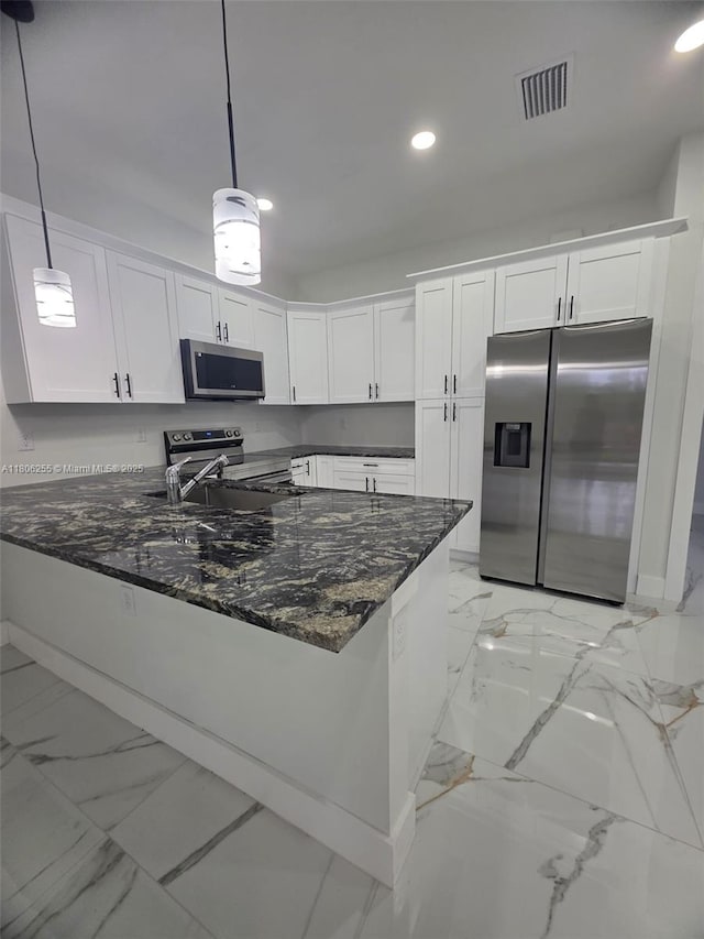 1145 SW Antonio St E, Lehigh Acres, FL 33974 - kitchen with appliances with stainless steel finishes, light marble finish flooring, dark stone countertops, recessed lighting, and a peninsula