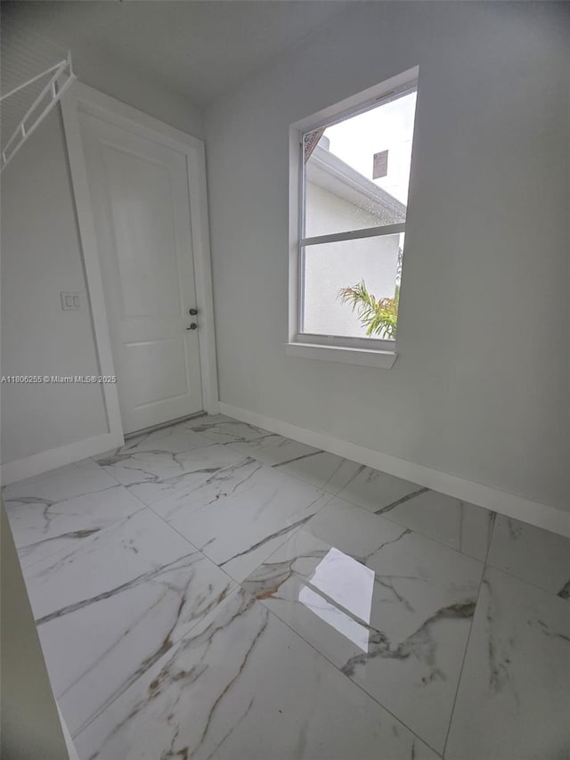 1145 SW Antonio St E, Lehigh Acres, FL 33974 - bonus room with baseboards and marble look tile flooring