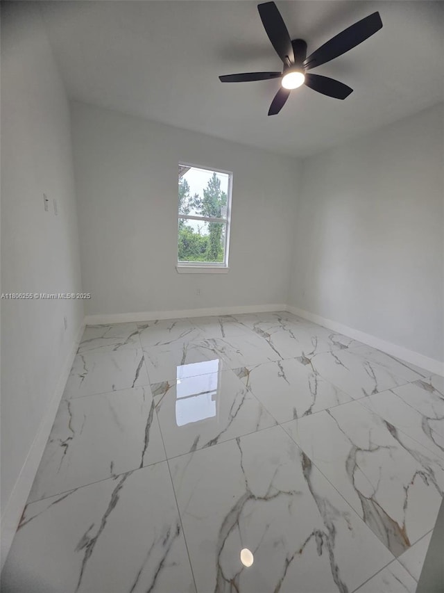 1145 SW Antonio St E, Lehigh Acres, FL 33974 - spare room featuring marble finish floors and a ceiling fan