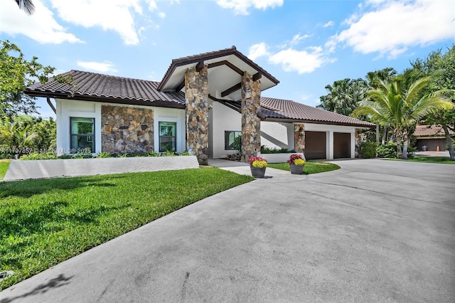 11850 SW 42nd Ct, Davie, FL 33330 - view of front of home with stone siding, a tiled roof, a front yard, a garage, and stucco siding