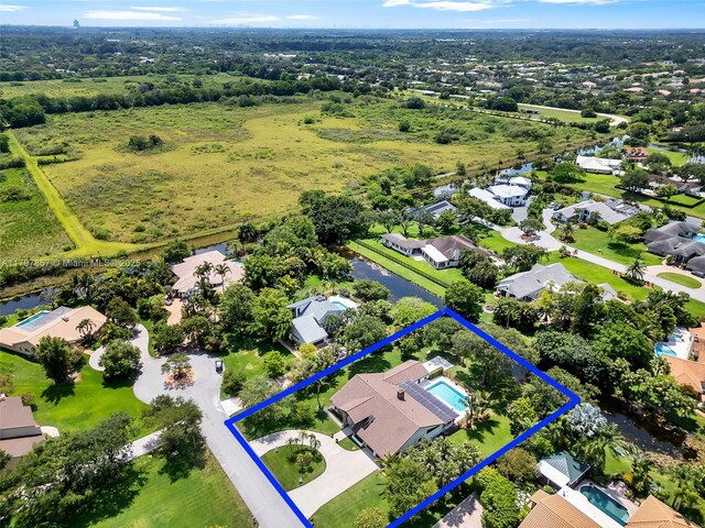 11850 SW 42nd Ct, Davie, FL 33330 - aerial perspective of suburban area featuring property parcel outlined and a large body of water