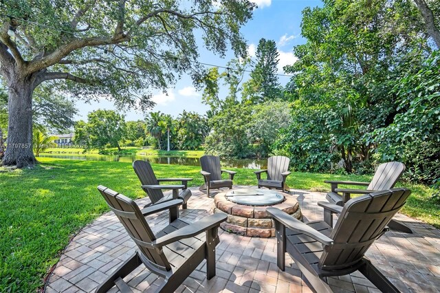 11850 SW 42nd Ct, Davie, FL 33330 - view of patio / terrace featuring an outdoor fire pit and a water view