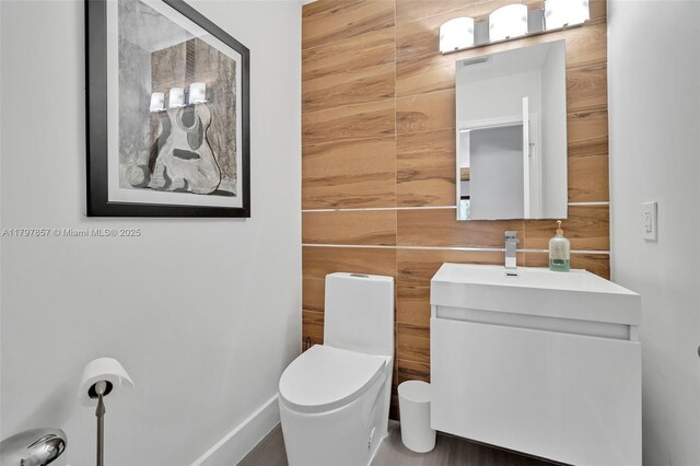 11850 SW 42nd Ct, Davie, FL 33330 - bathroom featuring vanity, toilet, and wooden walls