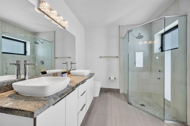 11850 SW 42nd Ct, Davie, FL 33330 - bathroom featuring double vanity, a stall shower, toilet, tile patterned flooring, and baseboards