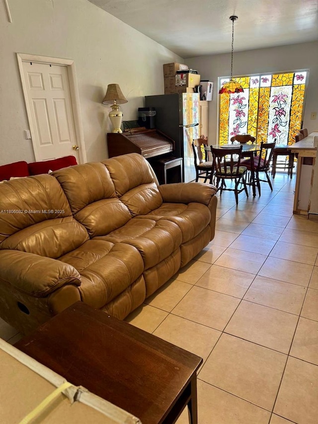 2804 26th SW, Lehigh Acres, FL 33976 - living room with light tile patterned floors and lofted ceiling