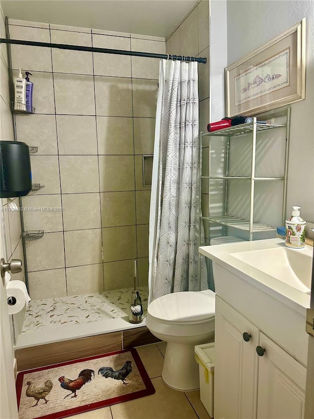 2804 26th SW, Lehigh Acres, FL 33976 - bathroom featuring a stall shower, toilet, tile patterned flooring, and vanity