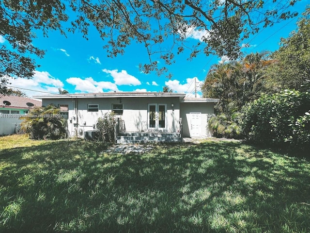 1231 N 16th Ct, Hollywood, FL 33020 - back of house with a lawn, french doors, and central AC unit