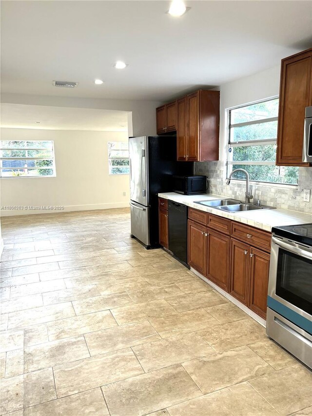 1416 SW 33ct, Fort Lauderdale, FL 33315 - kitchen featuring black appliances, a sink, light countertops, tasteful backsplash, and recessed lighting