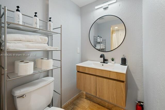 1416 SW 33ct, Fort Lauderdale, FL 33315 - bathroom featuring vanity, toilet, and baseboards