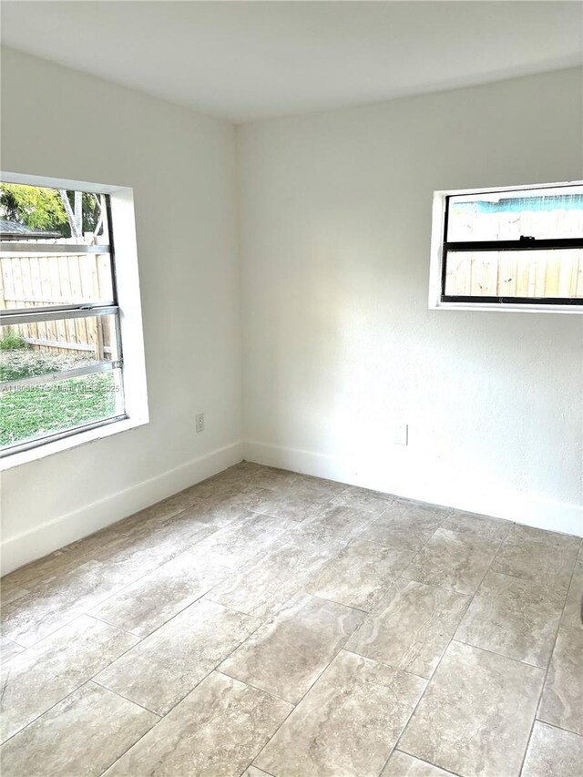 1416 SW 33ct, Fort Lauderdale, FL 33315 - unfurnished room featuring healthy amount of natural light and baseboards
