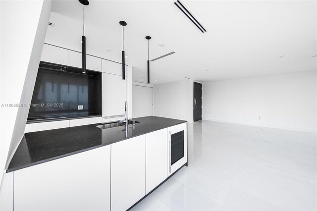 300 Biscayne Boulevard Way Unit 4507W, Miami, FL 33131 - kitchen featuring dark countertops, a sink, modern cabinets, and white cabinets