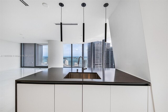 300 Biscayne Boulevard Way Unit 4507W, Miami, FL 33131 - kitchen featuring a sink, dark countertops, white cabinetry, and modern cabinets