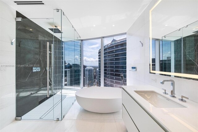 300 Biscayne Boulevard Way Unit 4507W, Miami, FL 33131 - full bathroom featuring vanity, a stall shower, a freestanding bath, and expansive windows