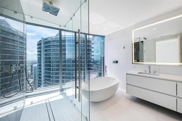 300 Biscayne Boulevard Way Unit 4507W, Miami, FL 33131 - full bath with vanity, a freestanding bath, tile walls, and a wall of windows