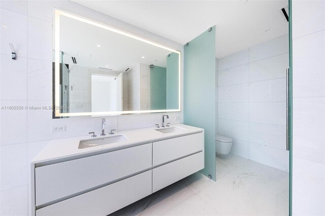 300 Biscayne Boulevard Way Unit 4507W, Miami, FL 33131 - full bath with tile walls, double vanity, toilet, marble finish flooring, and an enclosed shower