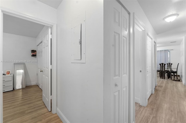 1812 NW 69th Ter, Miami, FL 33147 - hallway featuring light wood-style flooring, baseboards, and electric panel