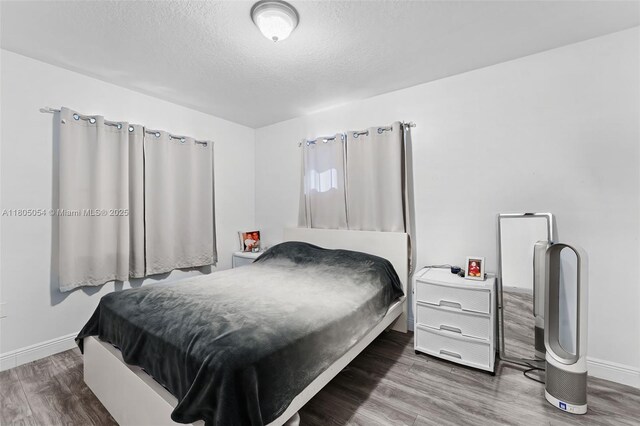 1812 NW 69th Ter, Miami, FL 33147 - bedroom with baseboards, wood finished floors, and a textured ceiling