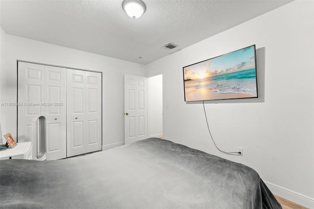 1812 NW 69th Ter, Miami, FL 33147 - carpeted bedroom featuring baseboards, a textured ceiling, and a closet