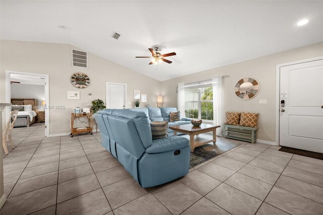 7434 Ashtabula St, Englewood, FL 34224 - living area with a ceiling fan, vaulted ceiling, light tile patterned floors, and baseboards