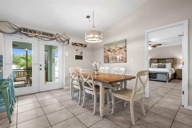 7434 Ashtabula St, Englewood, FL 34224 - dining area featuring vaulted ceiling, light tile patterned floors, french doors, a chandelier, and baseboards