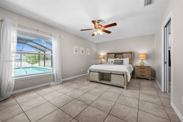 7434 Ashtabula St, Englewood, FL 34224 - bedroom with baseboards, light tile patterned floors, and ceiling fan