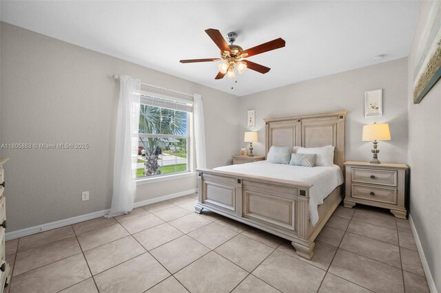 7434 Ashtabula St, Englewood, FL 34224 - bedroom featuring baseboards, light tile patterned flooring, and a ceiling fan