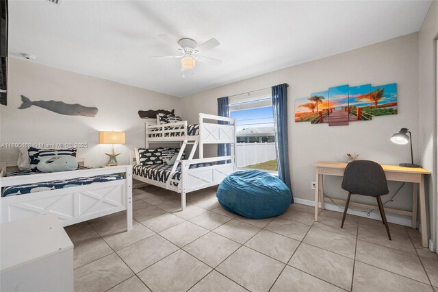 7434 Ashtabula St, Englewood, FL 34224 - bedroom featuring light tile patterned floors, a ceiling fan, and baseboards