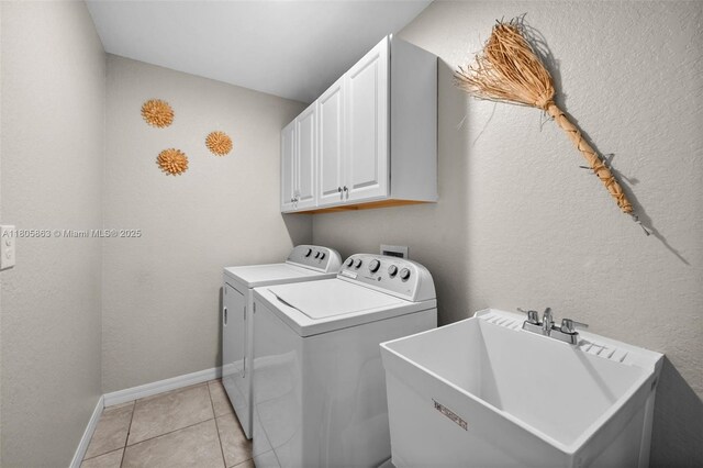 7434 Ashtabula St, Englewood, FL 34224 - washroom with independent washer and dryer, cabinet space, light tile patterned floors, baseboards, and a textured wall