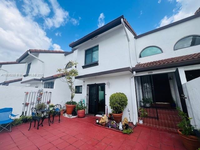 1271 SW 124th Ct Unit 2-D, Miami, FL 33184 - back of property with stucco siding, a patio area, and a tile roof