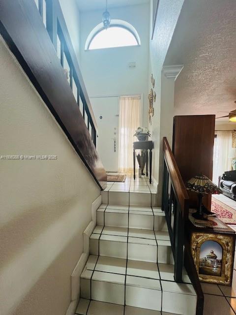 1271 SW 124th Ct Unit 2-D, Miami, FL 33184 - stairs with tile patterned flooring and a towering ceiling
