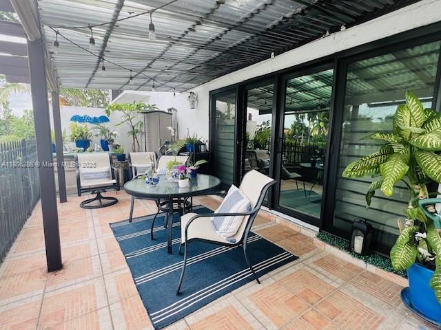 1271 SW 124th Ct Unit 2-D, Miami, FL 33184 - view of patio / terrace with outdoor dining space and fence
