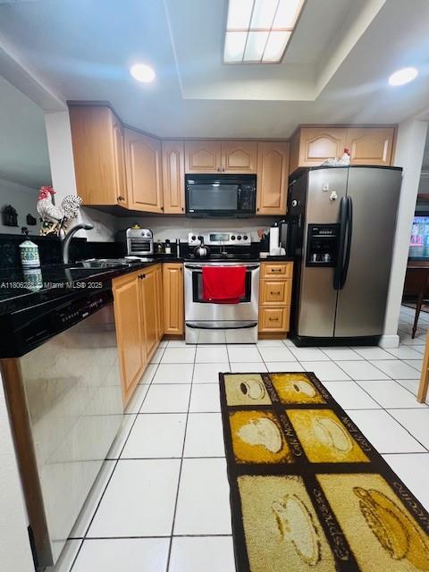 1271 SW 124th Ct Unit 2-D, Miami, FL 33184 - kitchen featuring stainless steel appliances, dark countertops, light tile patterned floors, and a tray ceiling