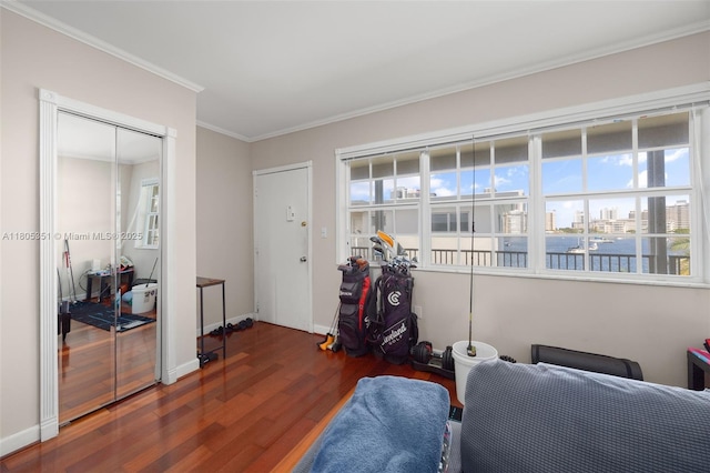 462 Golden Isles Dr Unit 305, Hallandale Beach, FL 33009 - sitting room featuring wood finished floors, ornamental molding, baseboards, and a water view
