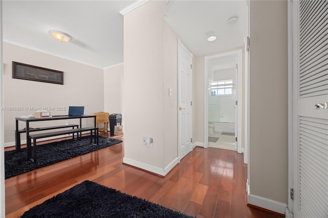 462 Golden Isles Dr Unit 305, Hallandale Beach, FL 33009 - hallway featuring wood finished floors, baseboards, ornamental molding, and a desk