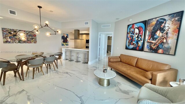 17111 Biscayne Blvd Unit 403, North Miami Beach, FL 33160 - living room featuring marble tiled flooring and a chandelier