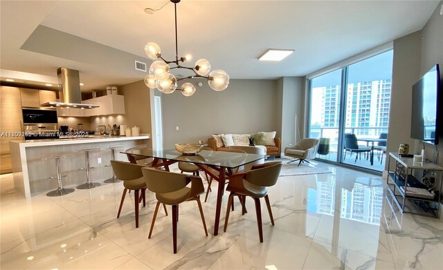 17111 Biscayne Blvd Unit 403, North Miami Beach, FL 33160 - dining area with expansive windows, light marble finish flooring, and a chandelier