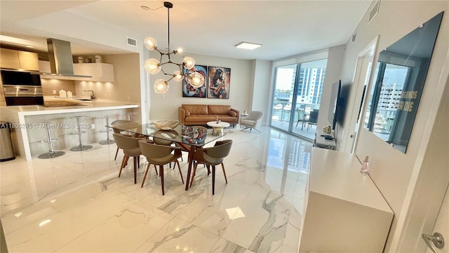 17111 Biscayne Blvd Unit 403, North Miami Beach, FL 33160 - dining area featuring a chandelier and light marble finish flooring