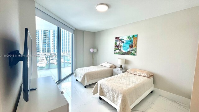 17111 Biscayne Blvd Unit 403, North Miami Beach, FL 33160 - bedroom with marble look tile flooring and baseboards