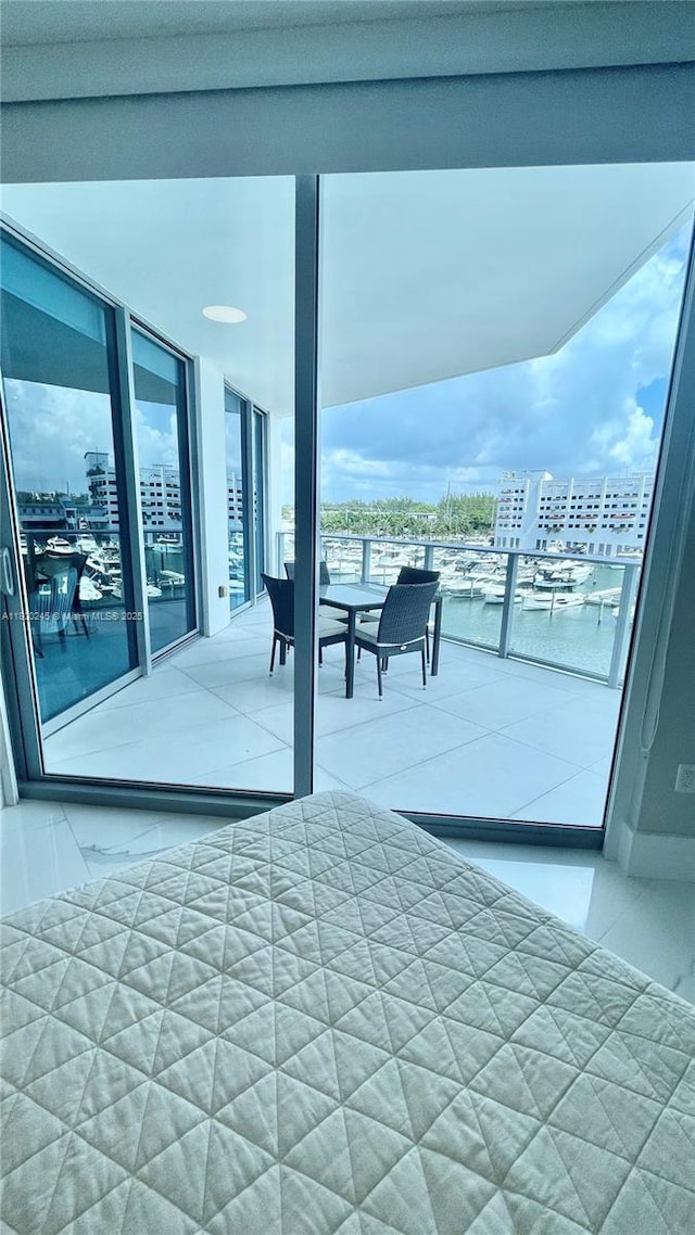 17111 Biscayne Blvd Unit 403, North Miami Beach, FL 33160 - bedroom with a view of city, tile patterned flooring, and expansive windows