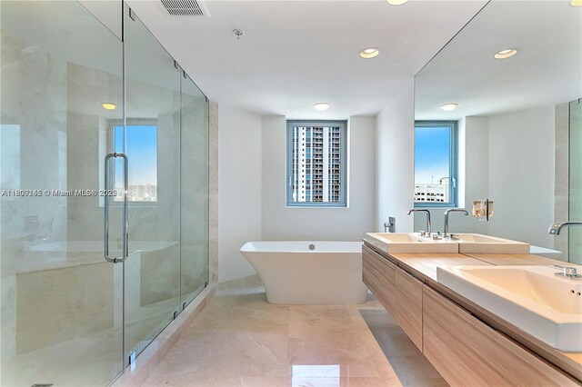 17111 Biscayne Blvd Unit 403, North Miami Beach, FL 33160 - full bathroom featuring a stall shower, a soaking tub, double vanity, and recessed lighting