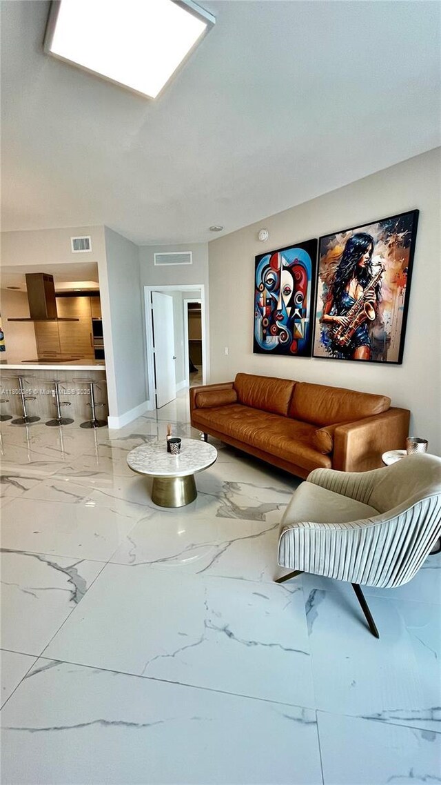 17111 Biscayne Blvd Unit 403, North Miami Beach, FL 33160 - living area with marble tiled floors and baseboards