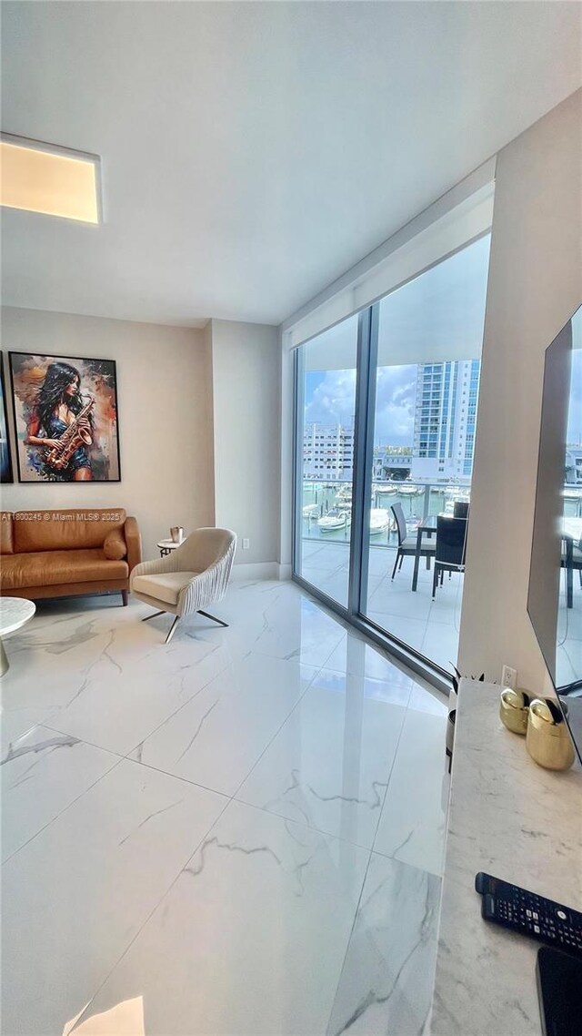 17111 Biscayne Blvd Unit 403, North Miami Beach, FL 33160 - living area featuring marble look tiles and expansive windows