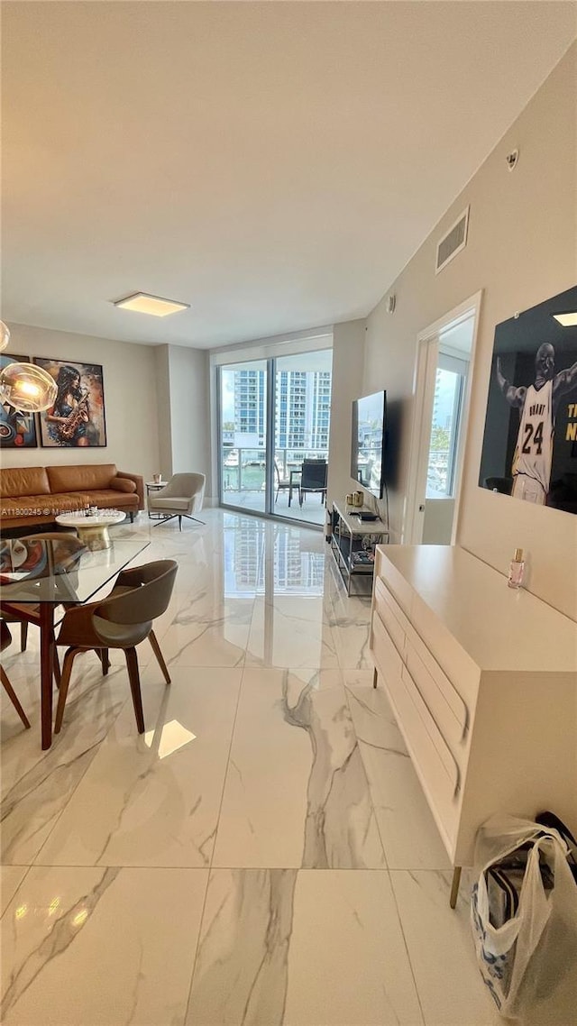 17111 Biscayne Blvd Unit 403, North Miami Beach, FL 33160 - living room with light marble finish flooring and floor to ceiling windows