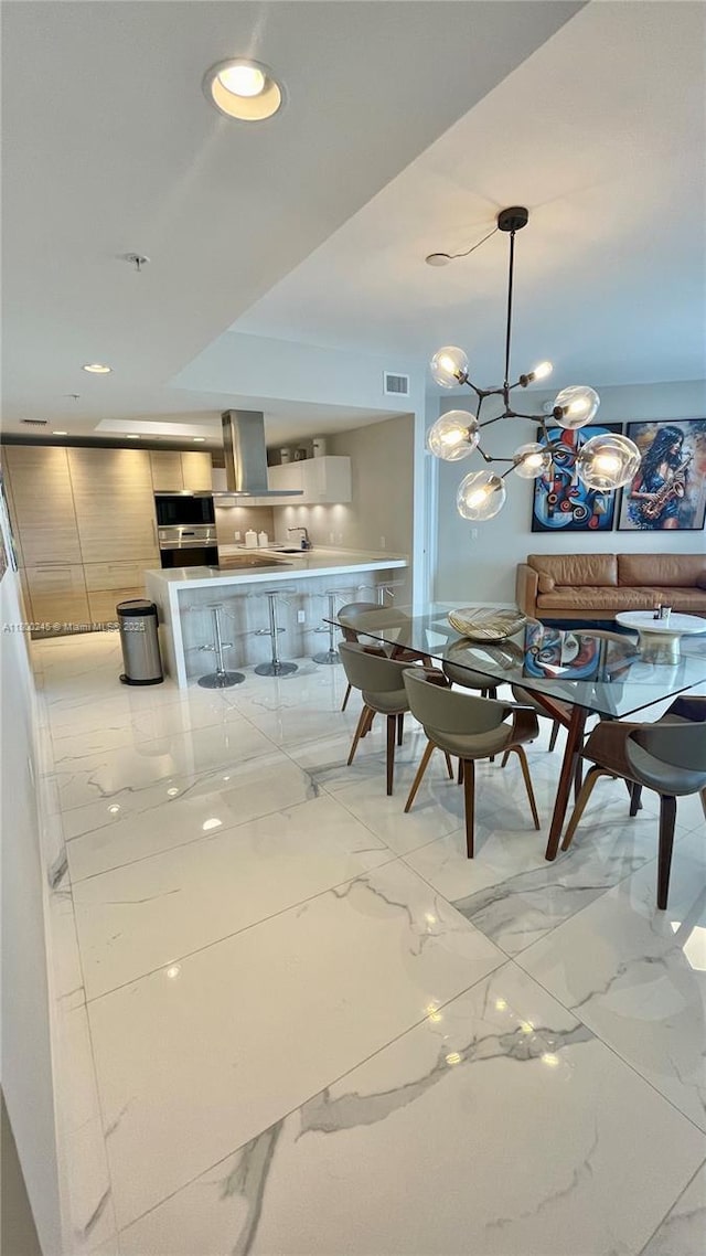17111 Biscayne Blvd Unit 403, North Miami Beach, FL 33160 - dining room featuring light marble finish floors, a chandelier, and recessed lighting