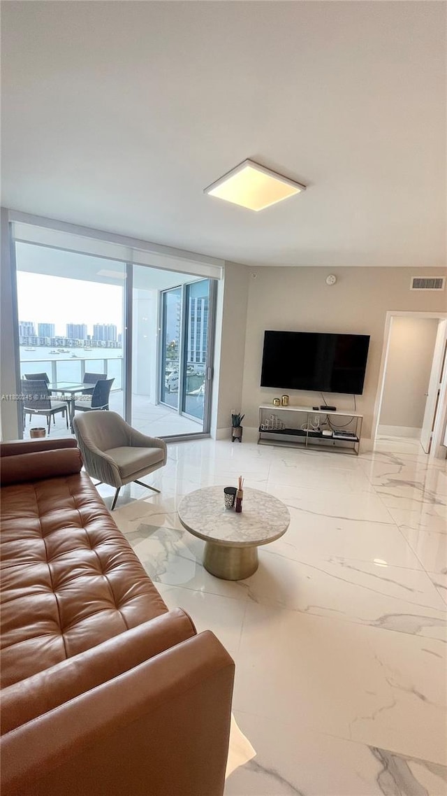 17111 Biscayne Blvd Unit 403, North Miami Beach, FL 33160 - living room featuring marble tiled floors and baseboards