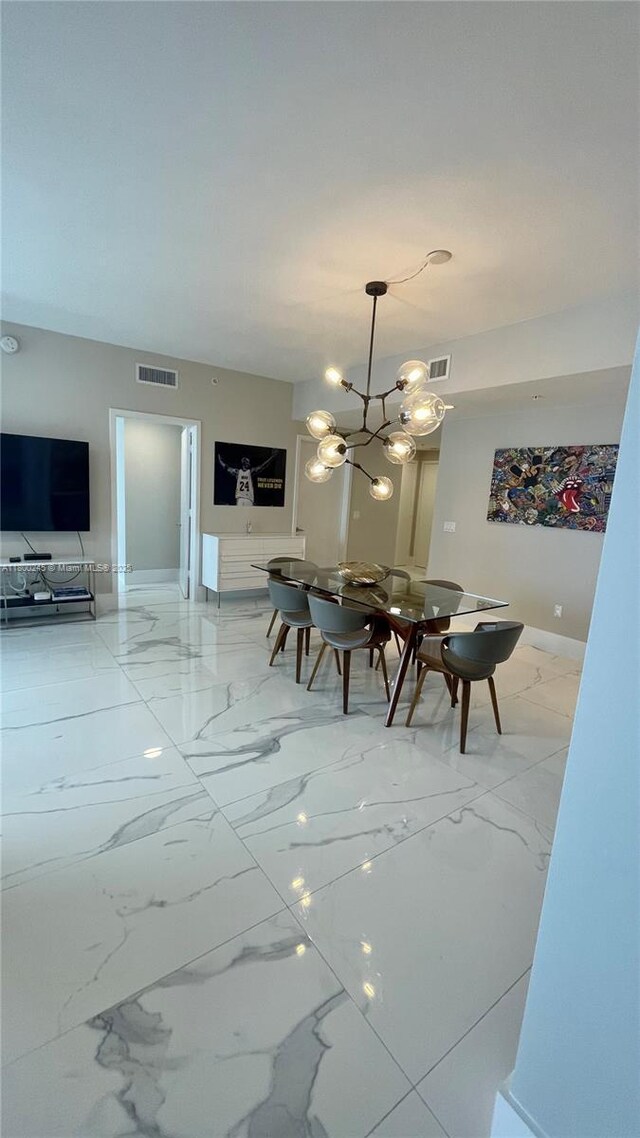 17111 Biscayne Blvd Unit 403, North Miami Beach, FL 33160 - dining space featuring marble finish floors and a chandelier