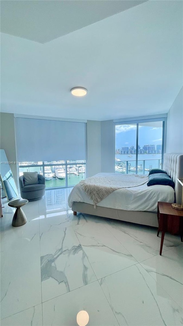 17111 Biscayne Blvd Unit 403, North Miami Beach, FL 33160 - bedroom with marble look tile flooring, a city view, floor to ceiling windows, and a water view