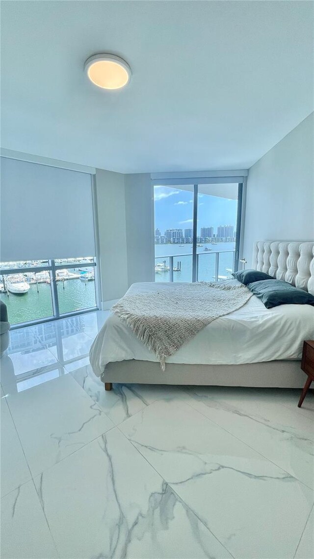 17111 Biscayne Blvd Unit 403, North Miami Beach, FL 33160 - bedroom featuring marble finish floors and a water view