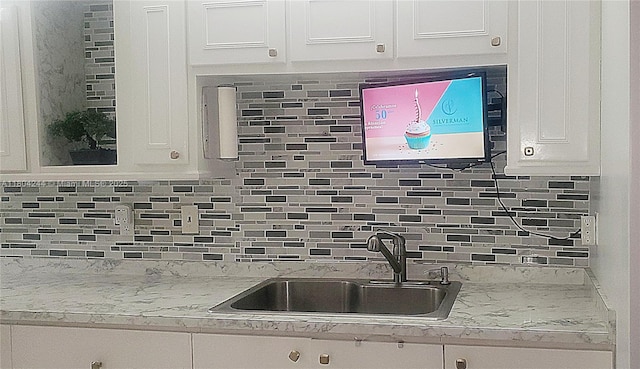 3905 N Nob Hill Rd Unit 510, Sunrise, FL 33351 - kitchen featuring a sink, white cabinetry, and tasteful backsplash